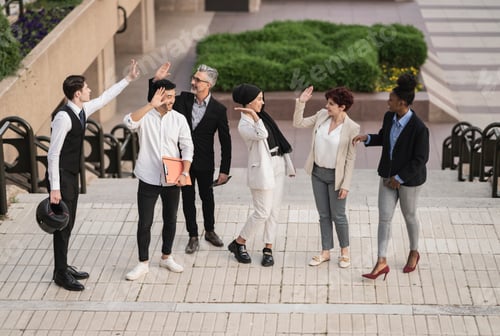 Preview: co-workers gathering outdoors,collide hands , businessmen shake hands outdoors