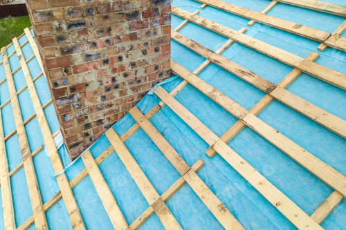 Preview: Aerial view of a wooden roof frame of brick house under construction.