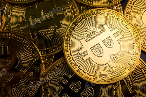 Preview: Close up of golden coins with bitcoin symbol background.