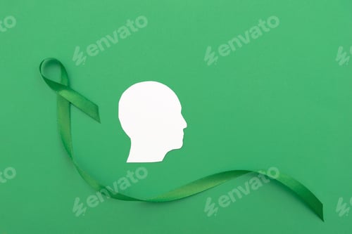 Preview: White Silhouette of a Human Head with Green Ribbon on Green Background for Mental Health Awareness