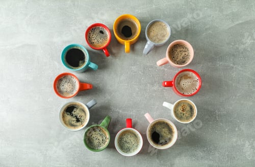 Preview: Multicolored cups of coffee circle on grey background, top view and space for text