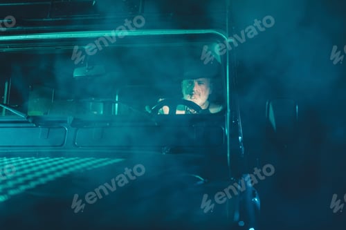 Preview: Serious Bearded Senior Man Driving His Vintage Four Wheel Vehicle Going Home On A Fuzzy Dark Night.