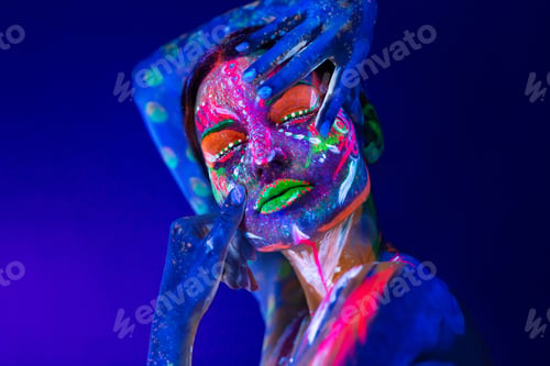 Preview: Body art on the body and hand of a girl glowing in the ultraviolet light
