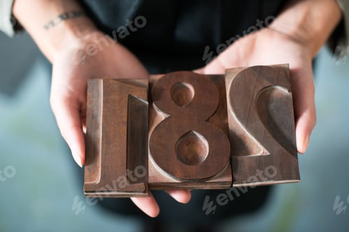 Preview: Womans hands holding traditional letterpress numerals workshop