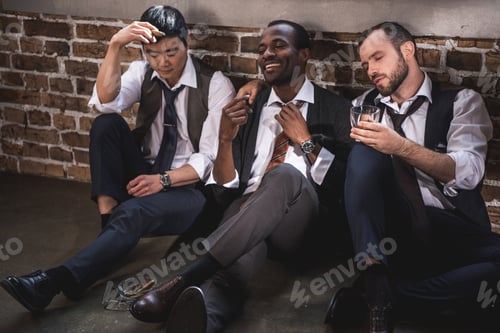 Preview: group of tired stylish businessmen resting together after work