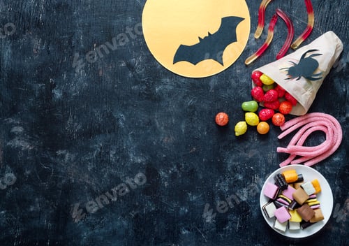 Preview: Colorful chewy, jelly, liquorice candies on a black background. Halloween holiday concept