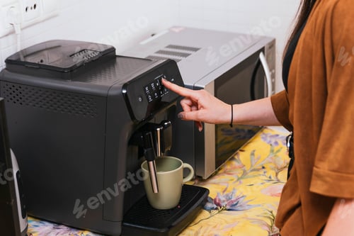 Preview: Woman Making Coffee at Home in the Kitchen