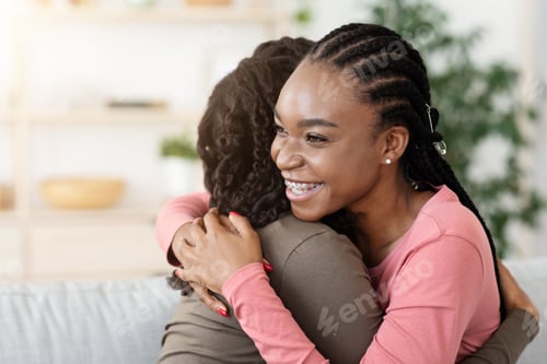 Preview: Pretty african american girlfriends hugging at home