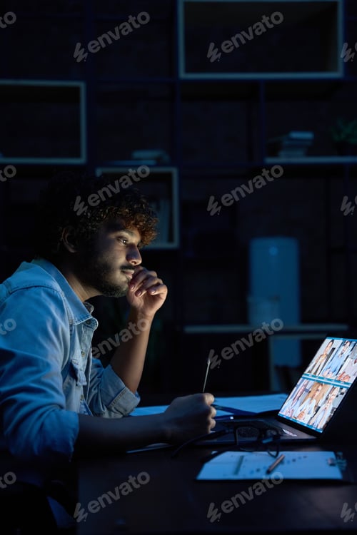 Preview: Young indian business man having video call virtual meeting late at night.