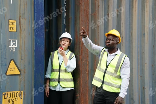 Preview: Foreman control loading Containers box from Cargo freight ship for import export.
