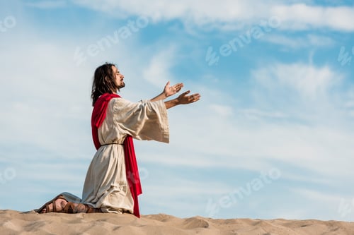Preview: jesus praying on knees on sand in desert against sky