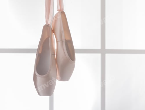 Preview: Pink ballet pointe shoes hanging on window