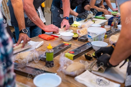 Preview: Sushi cooking workshop. Students practice with a Japanese chef