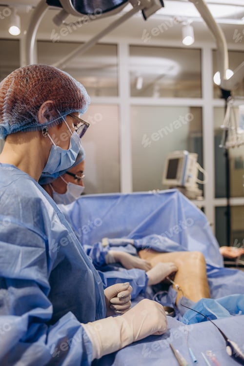 Preview: doctor and an assistant in the operating room for surgical venous vascular surgery clinic.