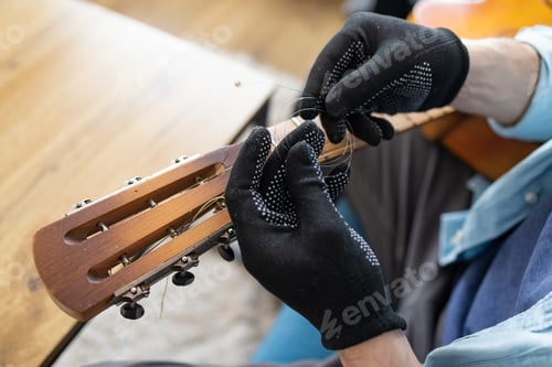 Preview: the technician setting up the guitar in the workshop
