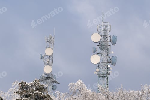 Preview: Radio towers and trees covered by snow in winter