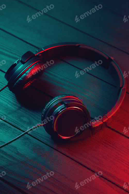 Preview: Black headphones on dark wooden background. Vintage style.