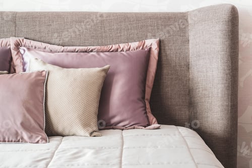 Preview: Soft Headboard and pillows in neutral beige colors. Fragment of cozy modern bedroom