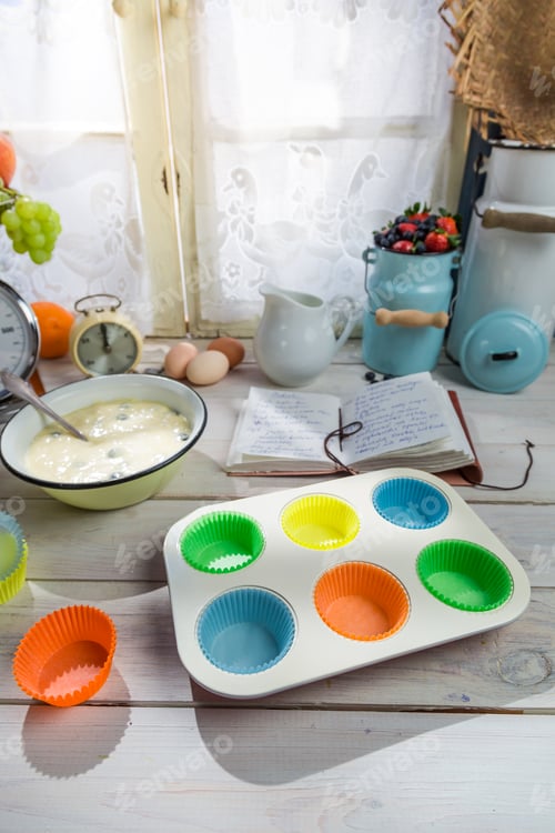 Preview: Baking tasty cupcakes with berry fruits on old white table
