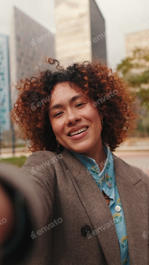Preview: Joyful Woman Selfie in Urban Cityscape Portrait