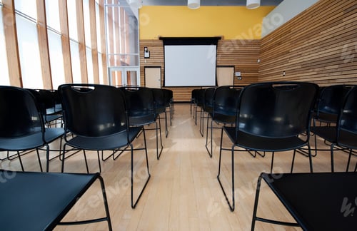 Preview: Chairs and projection screen in empty room