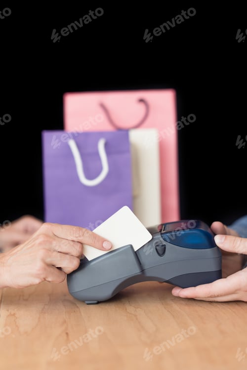 Preview: cropped shot of woman making payment with credit card in store