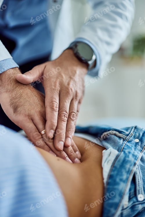 Preview: Doctor Performing Abdominal Examination During Medical Appointment in a Clinical Setting