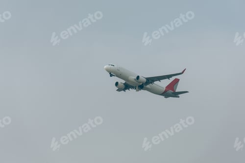 Preview: Low angle view of jet plane in cloudy sky