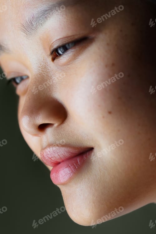 Preview: Close-up portrait of young asian female with smooth skin and soft expression