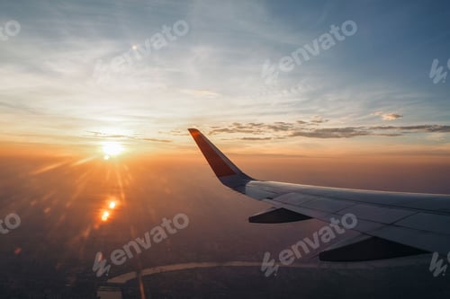 Preview: The wings of a passenger plane flying over Bangkok in the mornin