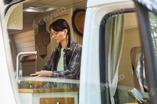 Preview: Woman washing vegetables in van