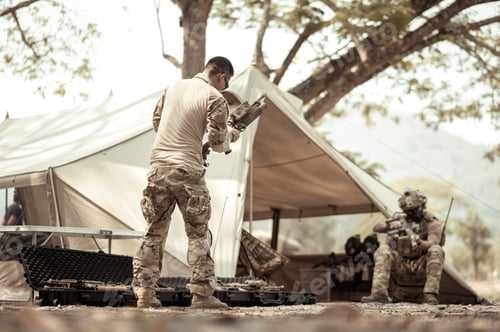Preview: Soldiers in camouflage uniforms planning on operation in the camp
