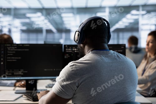 Preview: Employee working in computer network security data center listening music