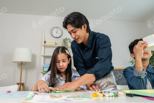 Preview: Asian teacher educating students in an art class at elementary school.