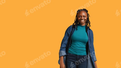 Preview: Frisky playful woman blowing kisses to camera, being flirty, studio background