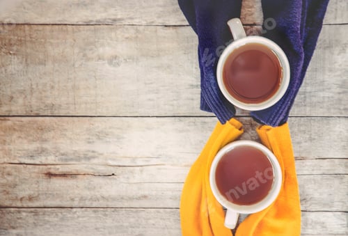 Preview: A cup of tea and a cozy autumn background. Selective focus.