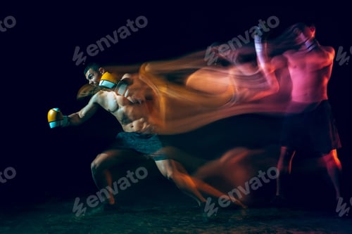 Preview: Male boxer boxing in a dark studio