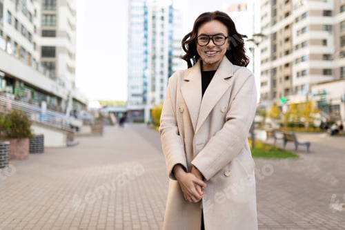 Preview: smiling european young woman designer on the background of a city street