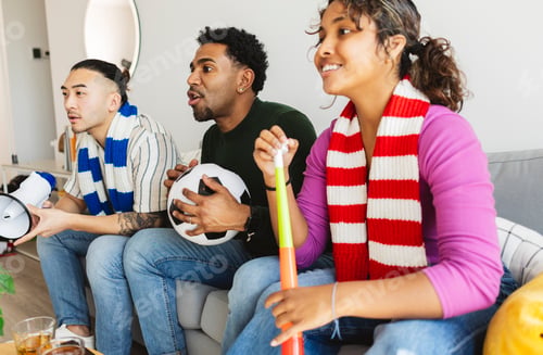 Preview: Diverse friends watching football game together at home