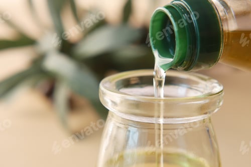 Preview: pouring natural olive oil from a bottle