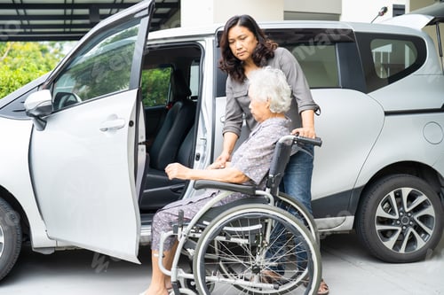Preview: Caregiver help and support asian elderly woman sitting on wheelchair prepare get to her car