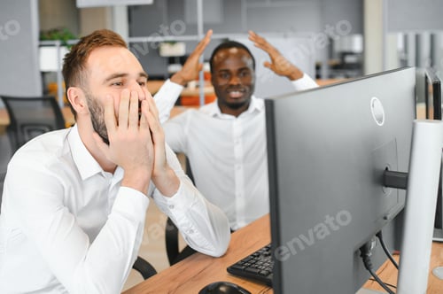 Preview: Two confident businessmen, financial analysts or investment advisers sitting at office desk