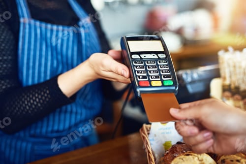 Preview: For your convenience. Cropped shot of an unrecognizable man paying for his purchase by card.