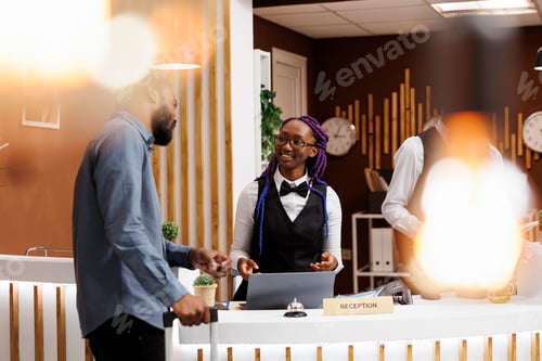 Preview: Hotel receptionist talking with guest