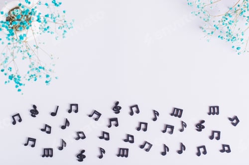 Preview: Conceptual background of black musical notes and dried flowers top view
