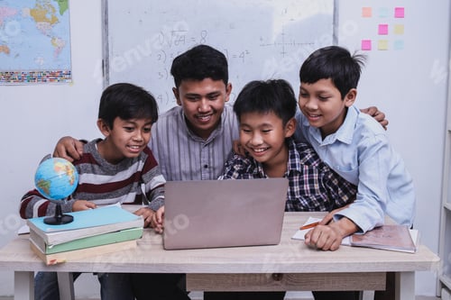 Preview: Teacher explain lesson using laptop to students at the classroom