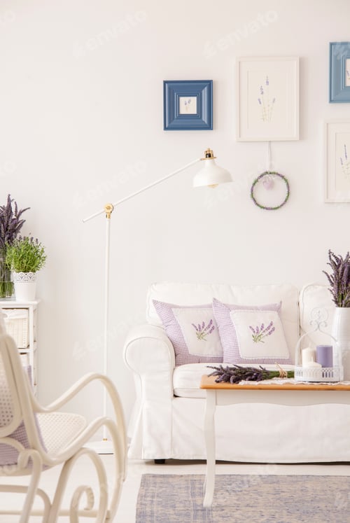 Preview: Cushions on white settee in living room interior with posters an