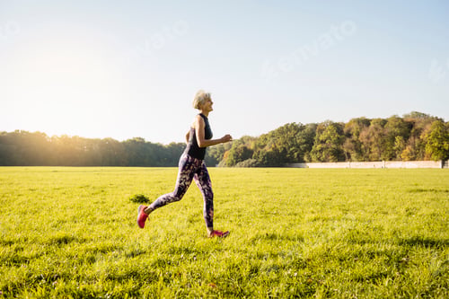 Preview: Senior woman running on rural meadow
