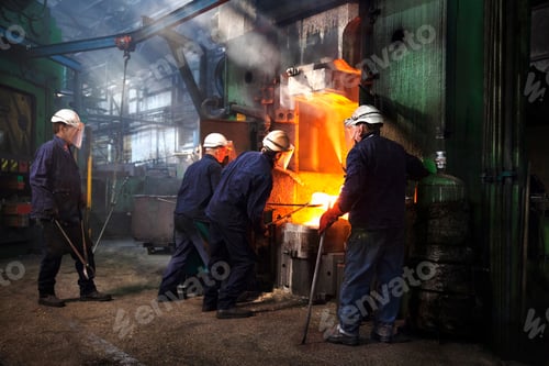Preview: Workers in protective gear handling molten metal at an industrial facility