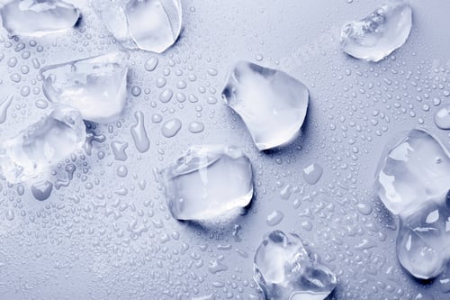 Preview: Pieces of crushed ice on light blue background, top view